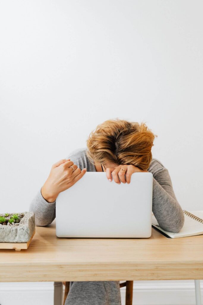 laptop | functional medicine doctor in Orland Park, IL | functional medicine | functional medicine for sleep | Homewood | Oak Lawn | Mokena Tired woman sitting at a desk slumped over a laptop. Learn to improve your energy and manage your blood sugar with functional medicine in Orland Park, IL.