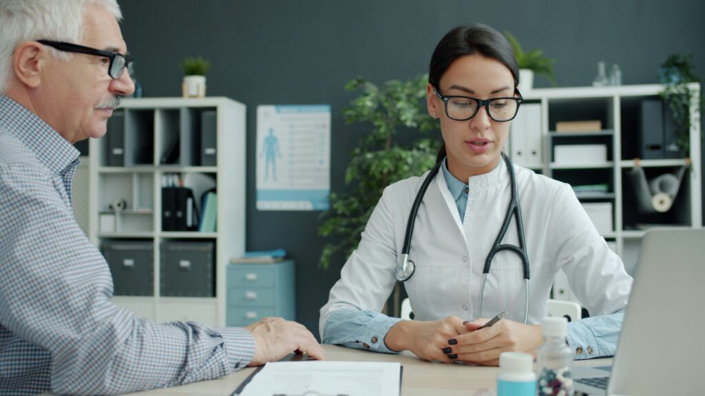Older man reviewing his test results with a functional medicine doctor in Orland Park, IL