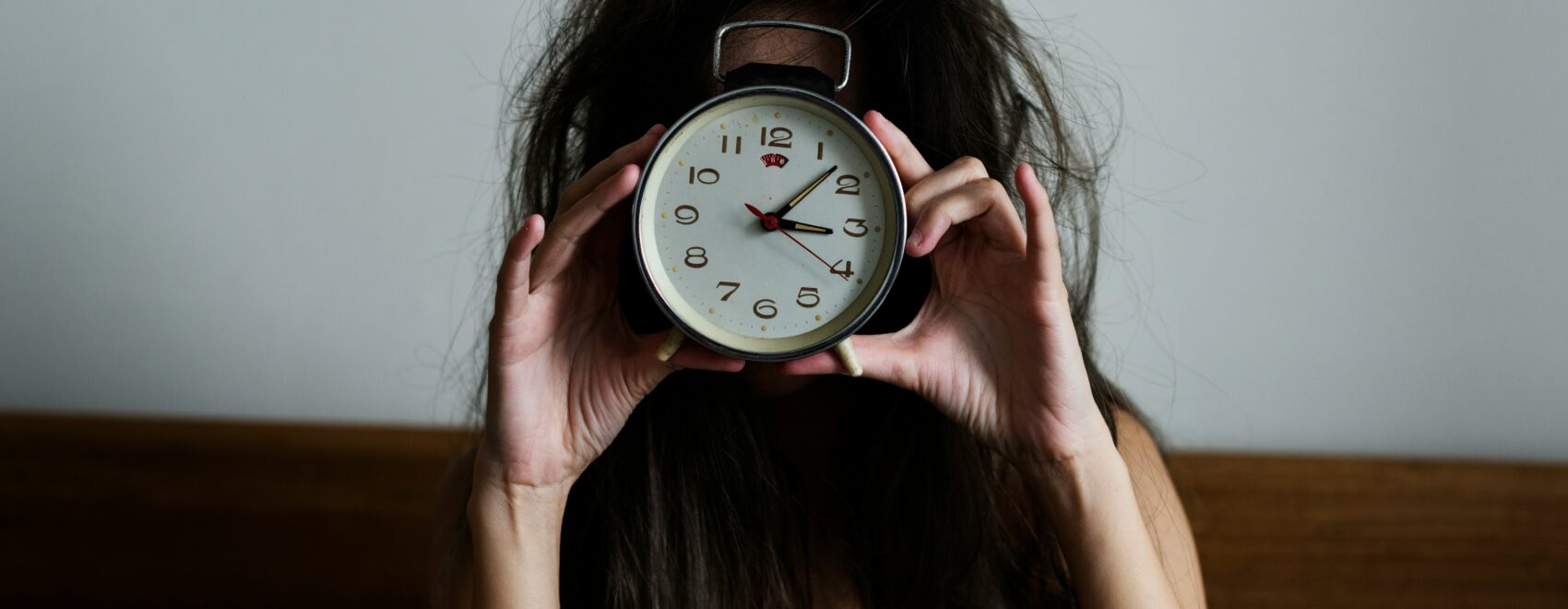 Woman holding a clock representing waking at 3am in Orland Park IL