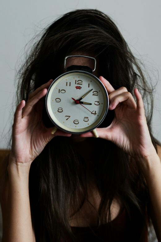 Woman holding a clock representing waking at 3am in Orland Park IL