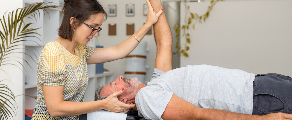 Female chiropractor using Applied Kinesiology to evaluate a male patients neck pain in Orland Park, Illinois. 