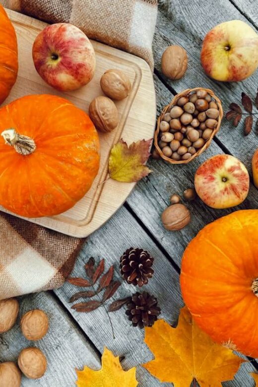 Pumpkins, apples, nuts and autumn leaves on a table in Orland Park, Illinois.
