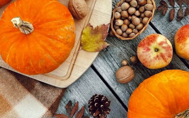 Pumpkins, apples, nuts and autumn leaves on a table in Orland Park, Illinois.