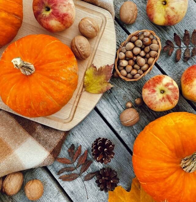 Pumpkins, apples, nuts and autumn leaves on a table in Orland Park, Illinois.